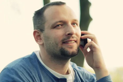 Young man talking on mobile phone, outdoors NTSC Stock Footage