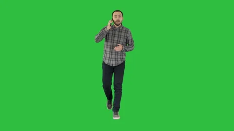 Young man talking on mobilephone on a Green Screen, Chroma Key. Stock Footage 99054905