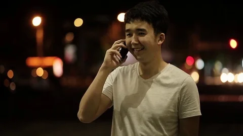 Young man talking on a phone and laughing Video stock 76379764