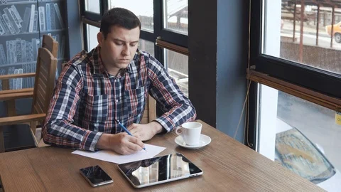 Young man talking on the phone in a cafe Stock-Footage 86490551