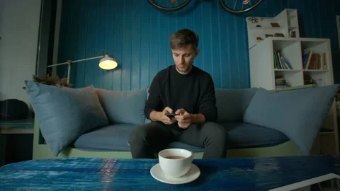 Young Man Talking by Phone in Cafe Video stock 97578286