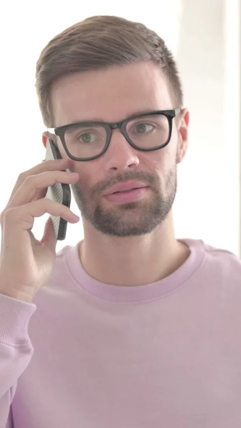 Young Man Talking on Phone, Discussing Work, Vertical Video Vídeo Stock 328972124