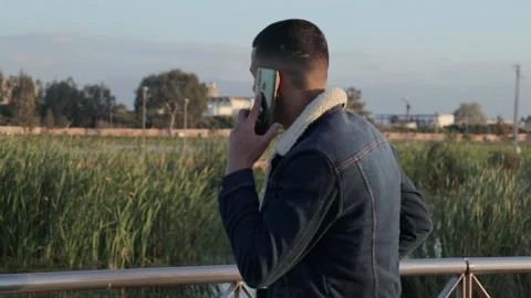 Young man talking on the phone Stock Footage