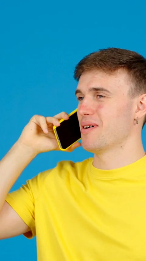 Young man talking on phone Stock Footage 254458356