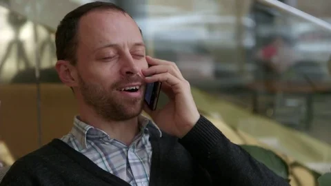 Young man talking on the phone from luxury hotel lobby Stock Footage 70989920