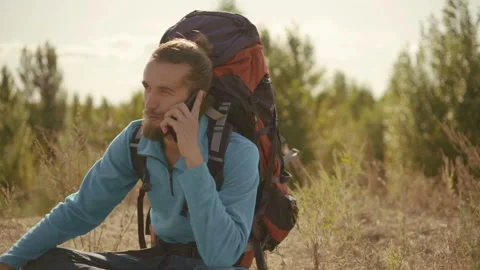 Young man talking on the phone on a mountain hike. Stock-Footage 116505602