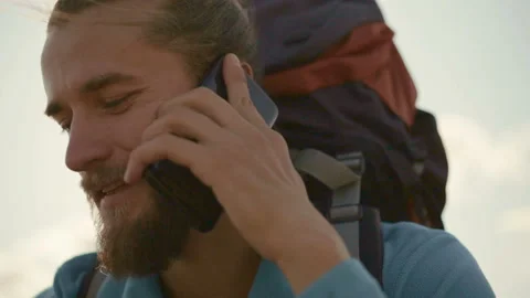 Young man talking on the phone on a mountain hike. Stock Footage 116510462