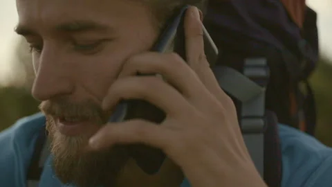 Young man talking on the phone on a mountain hike. Stock-Footage 116510471