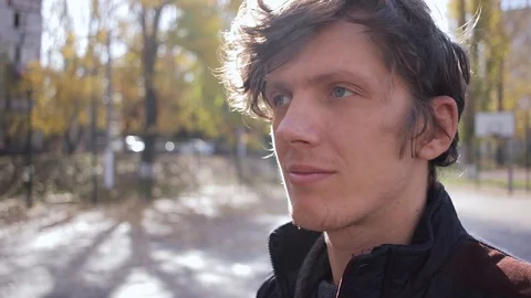 Young man talking on the phone outdoors in the park 動画素材 125088198