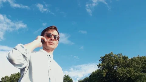 Young man talking on phone receiving good news and celebrating success Stock-Footage 77167328