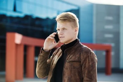 Young man talking on the phone, using smartphone, making a call. Stock Photos