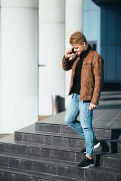 Young man talking on the phone, using smartphone, making a call. Stock Photos