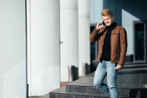 Young man talking on the phone, using smartphone, making a call. Stock Photos