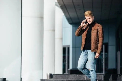 Young man talking on the phone, using smartphone, making a call. Stock Photos