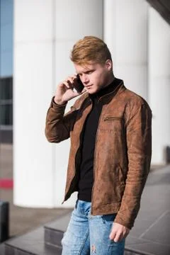 Young man talking on the phone, using smartphone, making a call. Stock Photos