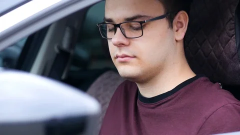 Young man talking on the phone while driving a car Stock Footage 126087333