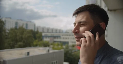 Young man talking on the phone, yard in the background Stock Footage 113285102