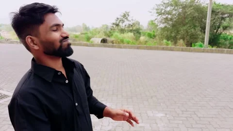 Young man talking seeing something pointing amazed and laughing on street Stock Footage 262248274