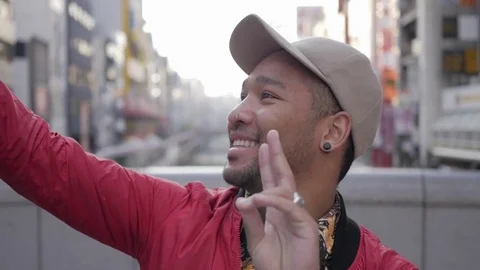 Young man talking selfies on Dotonbori bridge. Stock Footage 77784351