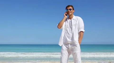 Young man talking on smart phone on hawaii beach Vacation travel concept Stock Footage 62908079