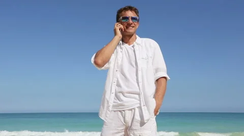 Young man talking on smart phone on hawaii beach Vacation travel concept Stock Footage 62908258