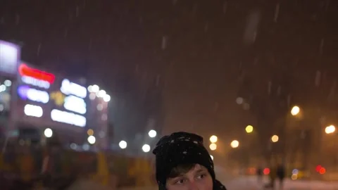 Young man talking on smart phone at night on street. Winter. Stock Footage 85979438