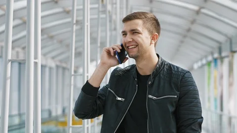 Young man talking on smartphone Stock Footage 108139951