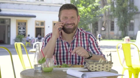 Young man talking by smartphone looking at camera. 動画素材 67604242