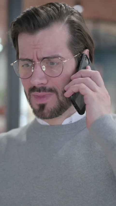Young Man Talking on Smartphone, Vertical Video Video stock 339581661