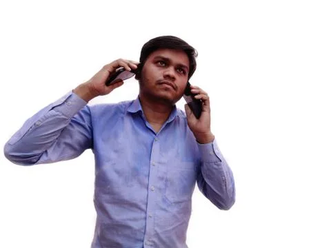 Young man talking on two mobile phone at a time ,he is too busy in business Stock Photos