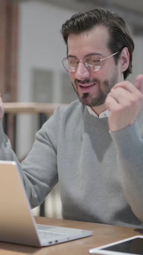 Young Man Talking on Video Call on Laptop in Office, Vertical Video Stock Footage 339580676