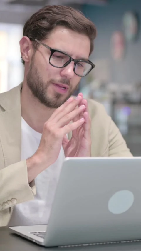 Young Man Talking on Video Call on Laptop at Work, Vertical Video Stock Footage 342003716