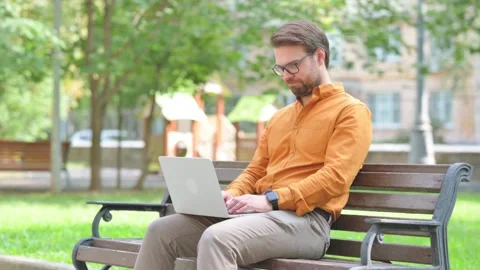 Young Man Talking for Video Chat on Laptop Outdoor Видео 282428579
