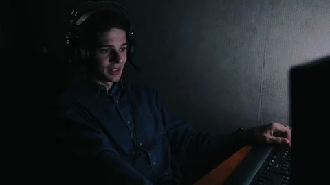 Young man talking on video confirence at home at night Stock Footage 99932207