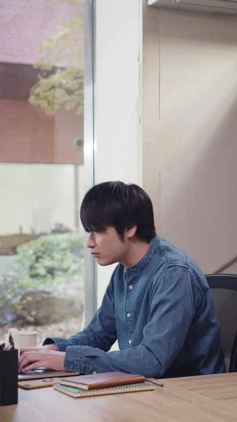 Young man talking while working on laptop Stock Footage 161920551