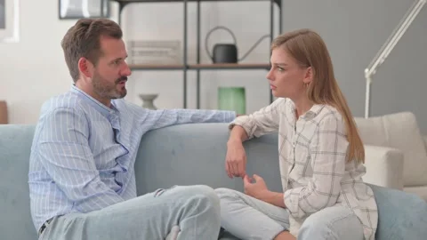 Young Man Talking with Wife while Sitting on Sofa at Home Stock Footage 287895210