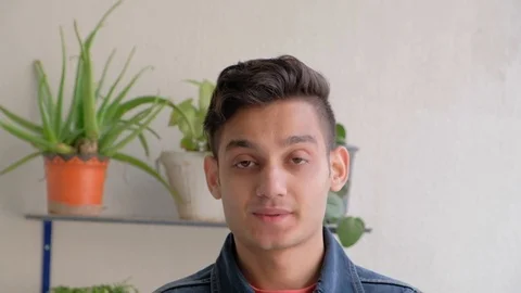 Young man talks to someone off camera as he wonders and tries to think of a solu Stock Footage 101286818