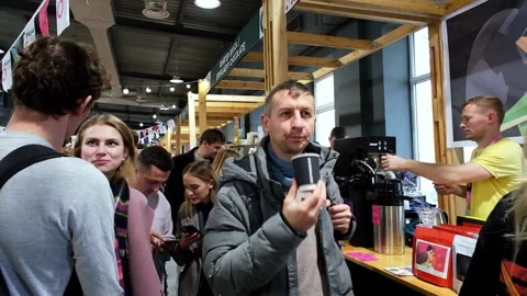 Young man tastes coffee at the Cup Festival 스톡 동영상 253863601
