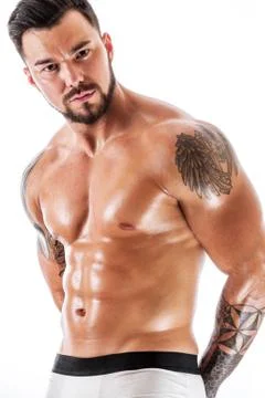 Young man with tattooed torso posing in underwear Stock Photos
