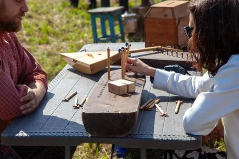 Young Man Teaching Folk Game at Outdoor Festival Stock Photos