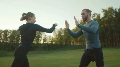 Young man teaching girlfriend how to box doing exercises together workout sport Stock Footage 138649431