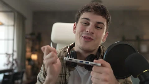 Young man technology blogger record video blog or v-log of new gadget Stock Footage 292562269