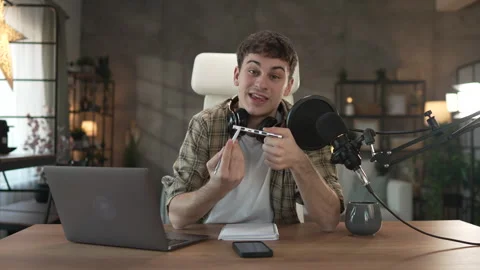 Young man technology blogger record video blog or v-log of new gadget Stock Footage 292562324