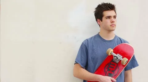 Young Man Teen Male Grunge Standing Against Wall with Skateboard Stock Footage