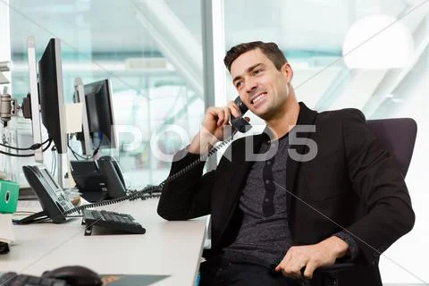 Young Man On Telephone In It Office