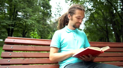 A young man is telling about a book Stock Footage 65053025