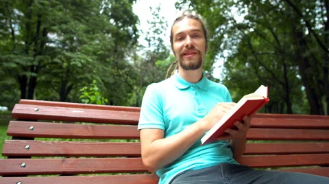A young man is telling about the book Stock Footage 65085248