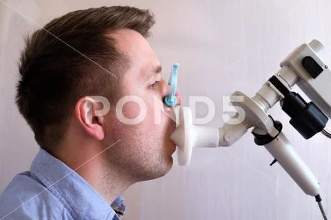 Young man testing breathing function by spirometry Stock Photos