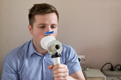 Young man testing breathing function by spirometry Stock Photos