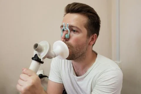 Young man testing breathing function by spirometry Stock Photos
